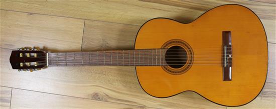 A classical guitar and soft case